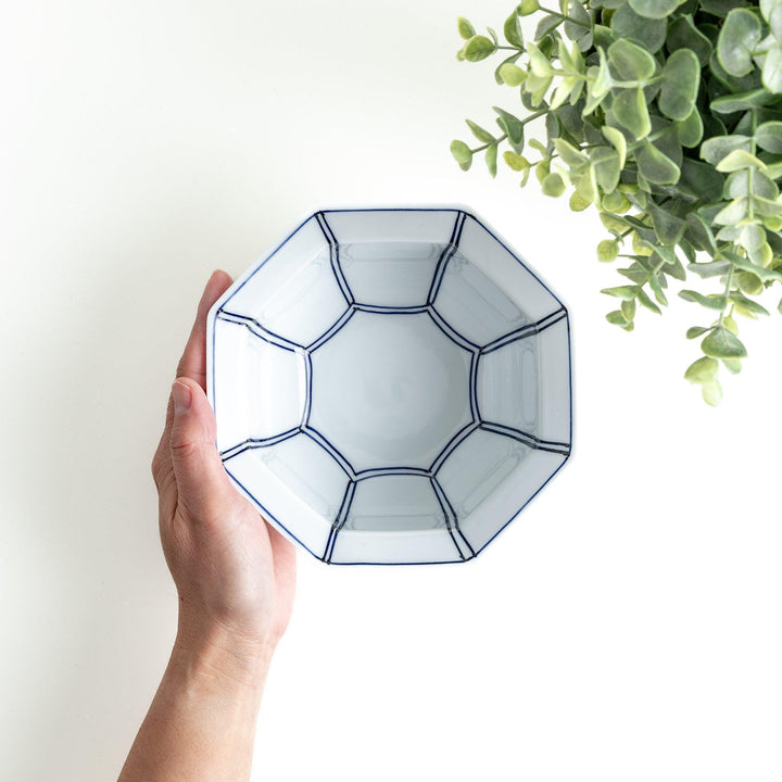An octagonal porcelain cereal bowl with a minimalist grid pattern