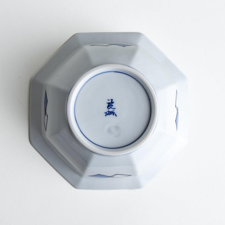 An octagonal porcelain cereal bowl with a minimalist grid pattern