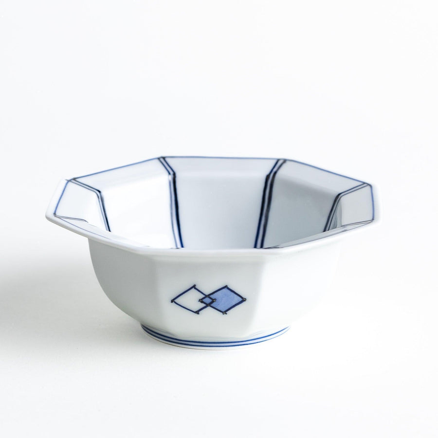 An octagonal porcelain dessert bowl with a minimalist grid pattern.
