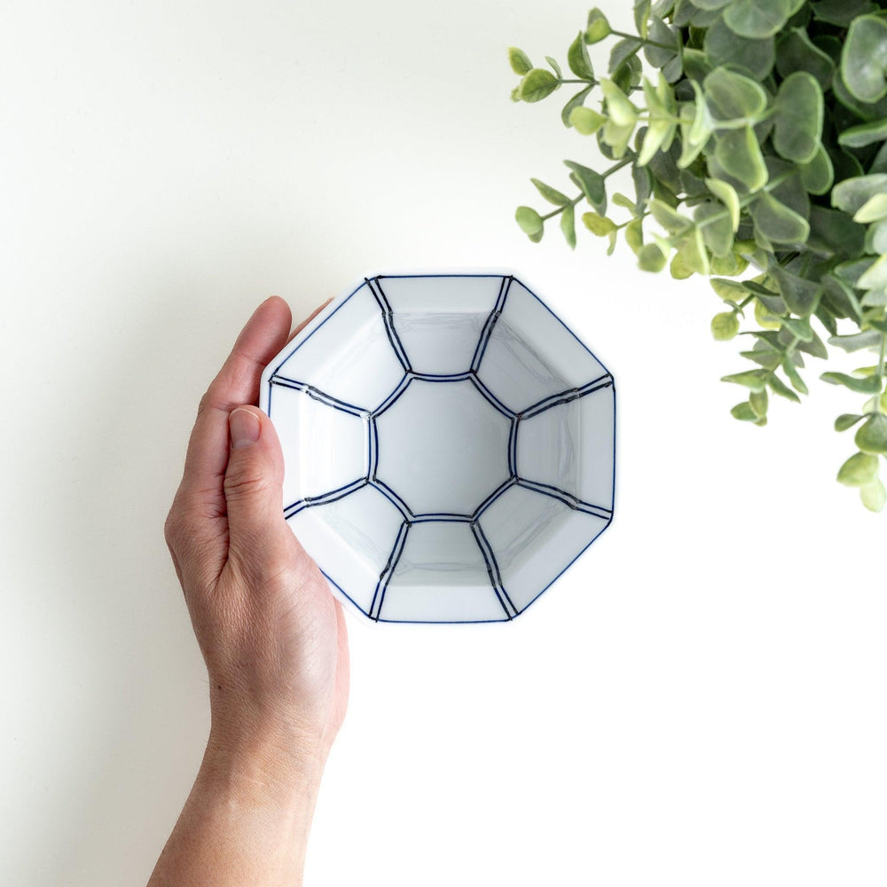 An octagonal porcelain dessert bowl with a minimalist grid pattern.