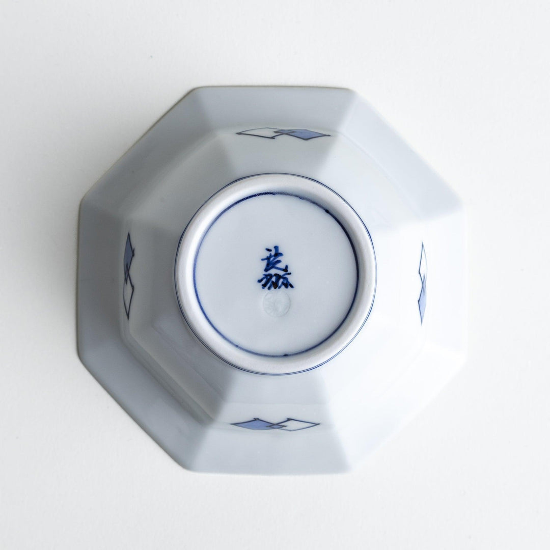An octagonal porcelain dessert bowl with a minimalist grid pattern.