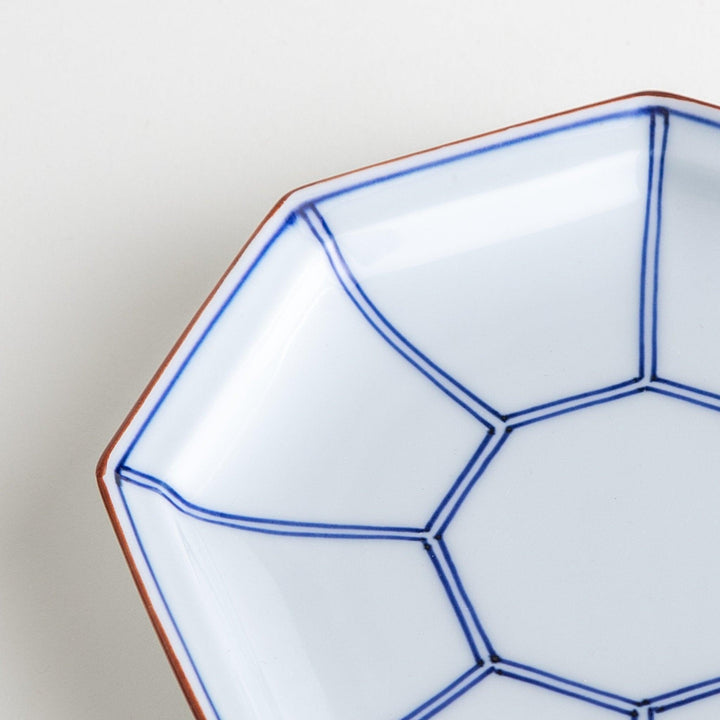 An octagonal porcelain large dessert plate with a minimalist grid pattern.