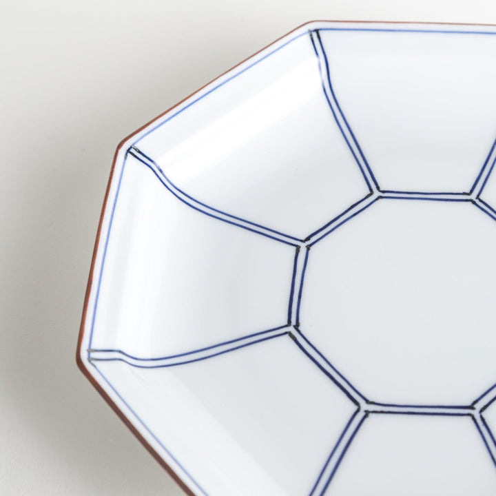 An octagonal porcelain salad plate with a minimalist grid pattern.
