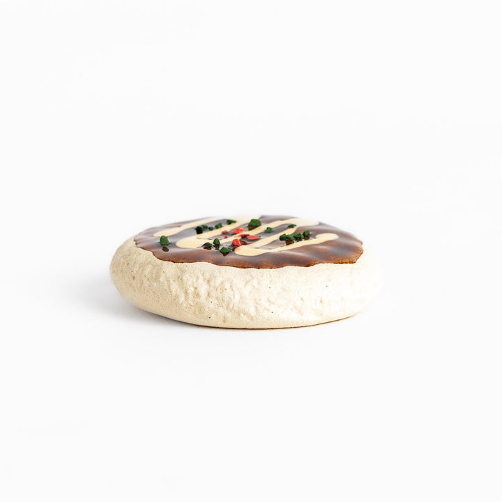 Fun Okonomiyaki-shaped chopstick rest with realistic details, including drizzled sauce and colorful toppings.