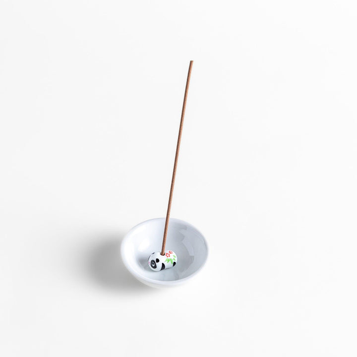 White ceramic incense holder featuring an adorable panda-shaped holder with floral accents, offering a charming and playful touch to incense rituals and home decor.