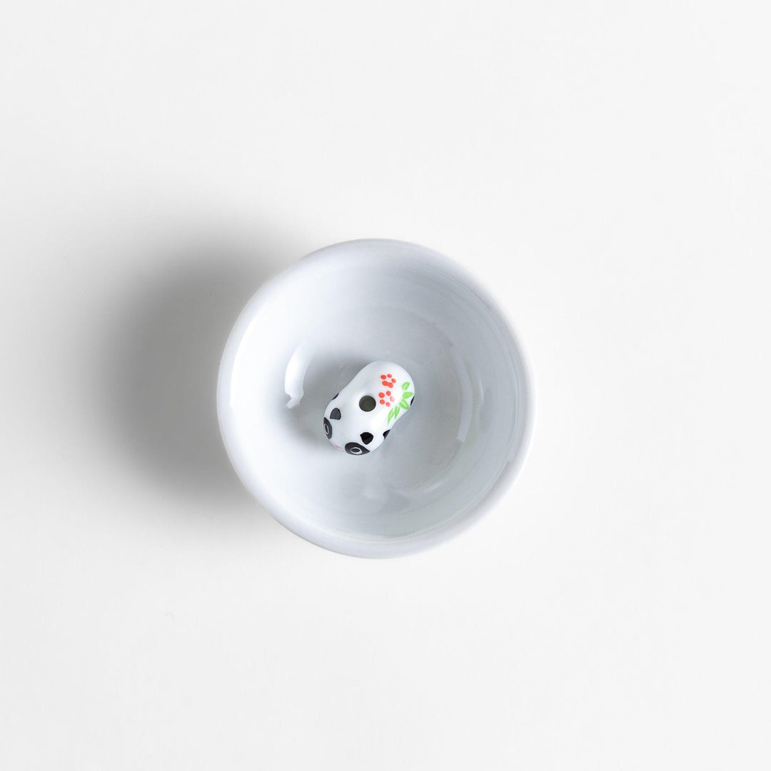 White ceramic incense holder featuring an adorable panda-shaped holder with floral accents, offering a charming and playful touch to incense rituals and home decor.