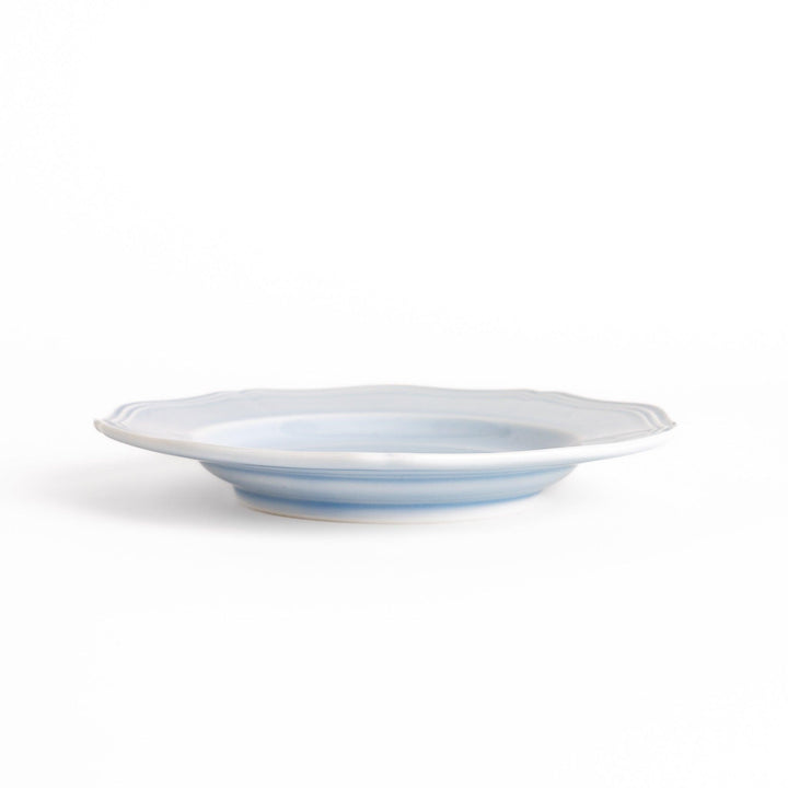 Pretty blue dessert plate with a delicate scalloped edge, ideal for showcasing your favorite treats.