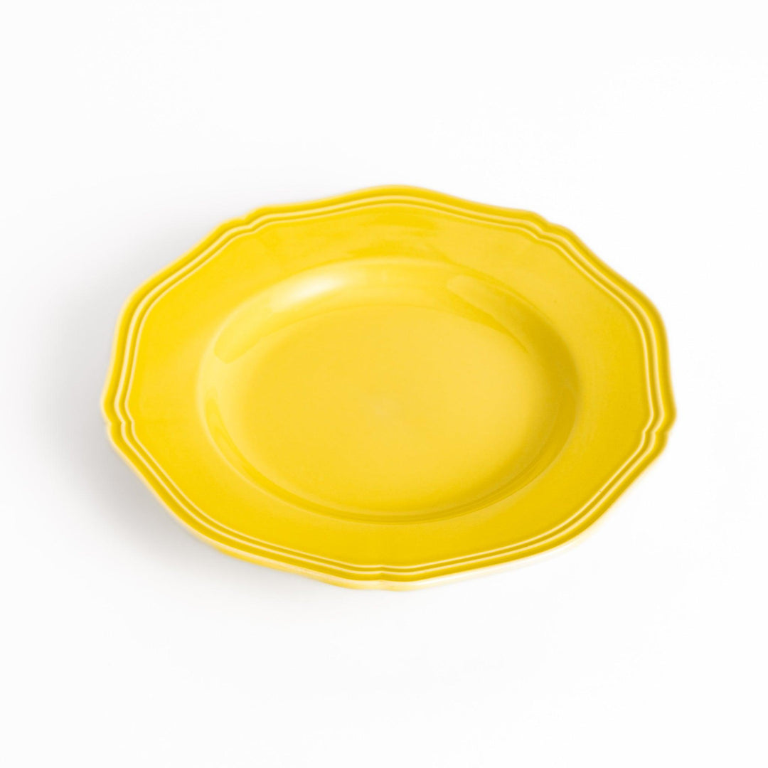 Pretty yellow dessert plate with a delicate scalloped edge, ideal for showcasing your favorite treats.
