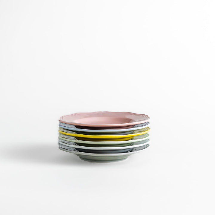 A stack of six pastel-colored dessert plates in pink, blue, yellow, green, white, and gray, each featuring an elegant scalloped edge, perfect for adding a delicate touch to your table.