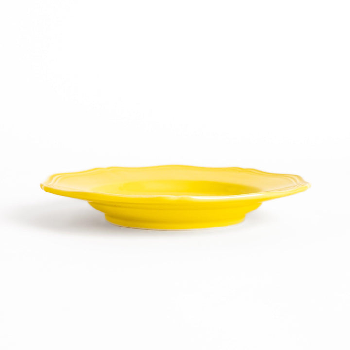 Pretty yellow dessert plate with a delicate scalloped edge, ideal for showcasing your favorite treats.