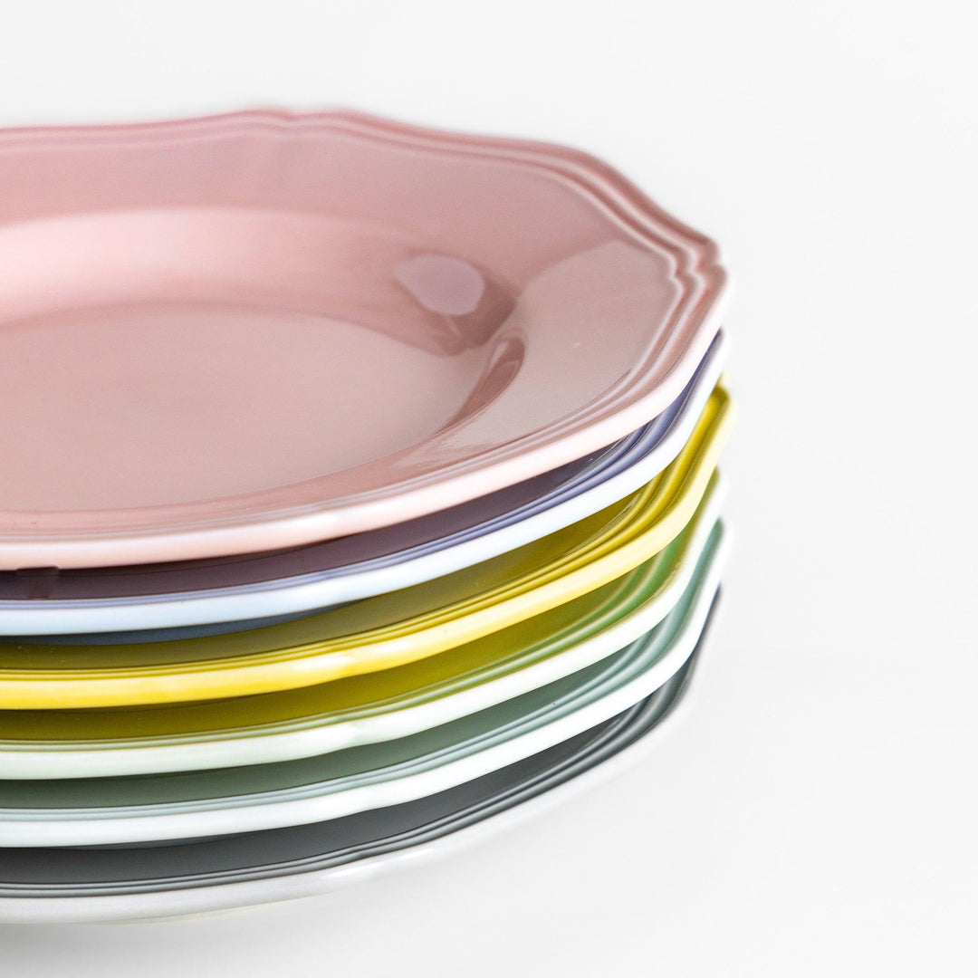 A stack of six pastel-colored dessert plates in pink, blue, yellow, green, white, and gray, each featuring an elegant scalloped edge, perfect for adding a delicate touch to your table.
