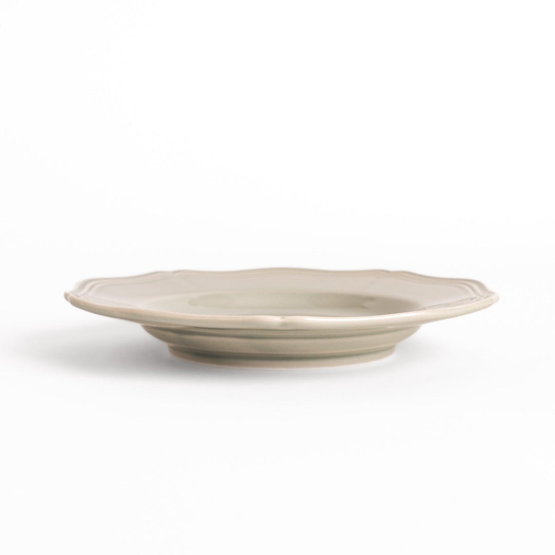 Pretty gray dessert plate with a delicate scalloped edge, ideal for showcasing your favorite treats.