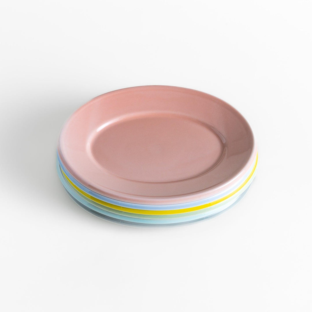 A stack of six pastel-colored oval salad plates in pink, blue, yellow, green, white, and gray, each with a smooth, glossy finish, perfect for adding a soft, serene touch to your table setting.