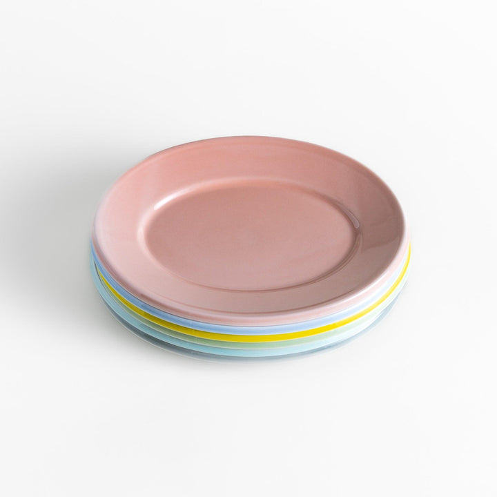 A stack of six pastel-colored oval salad plates in pink, blue, yellow, green, white, and gray, each with a smooth, glossy finish, perfect for adding a soft, serene touch to your table setting.