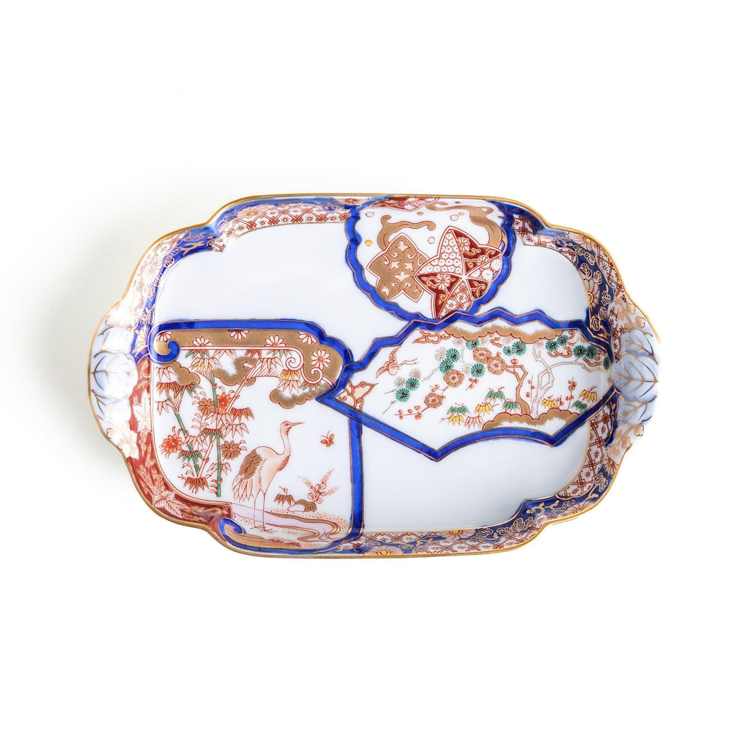 A rectangular salad plate with handles, decorated with scenes of cranes and trees in a traditional Japanese style, bordered by intricate red, blue, and gold patterns.