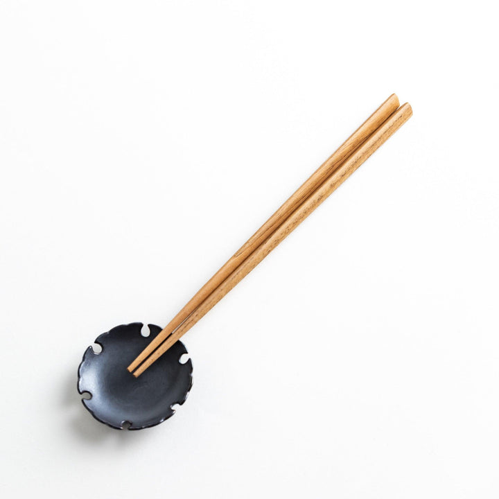Three pairs of natural chestnut wood chopsticks, each with a different geometric shape—triangle, hexagon, and round.