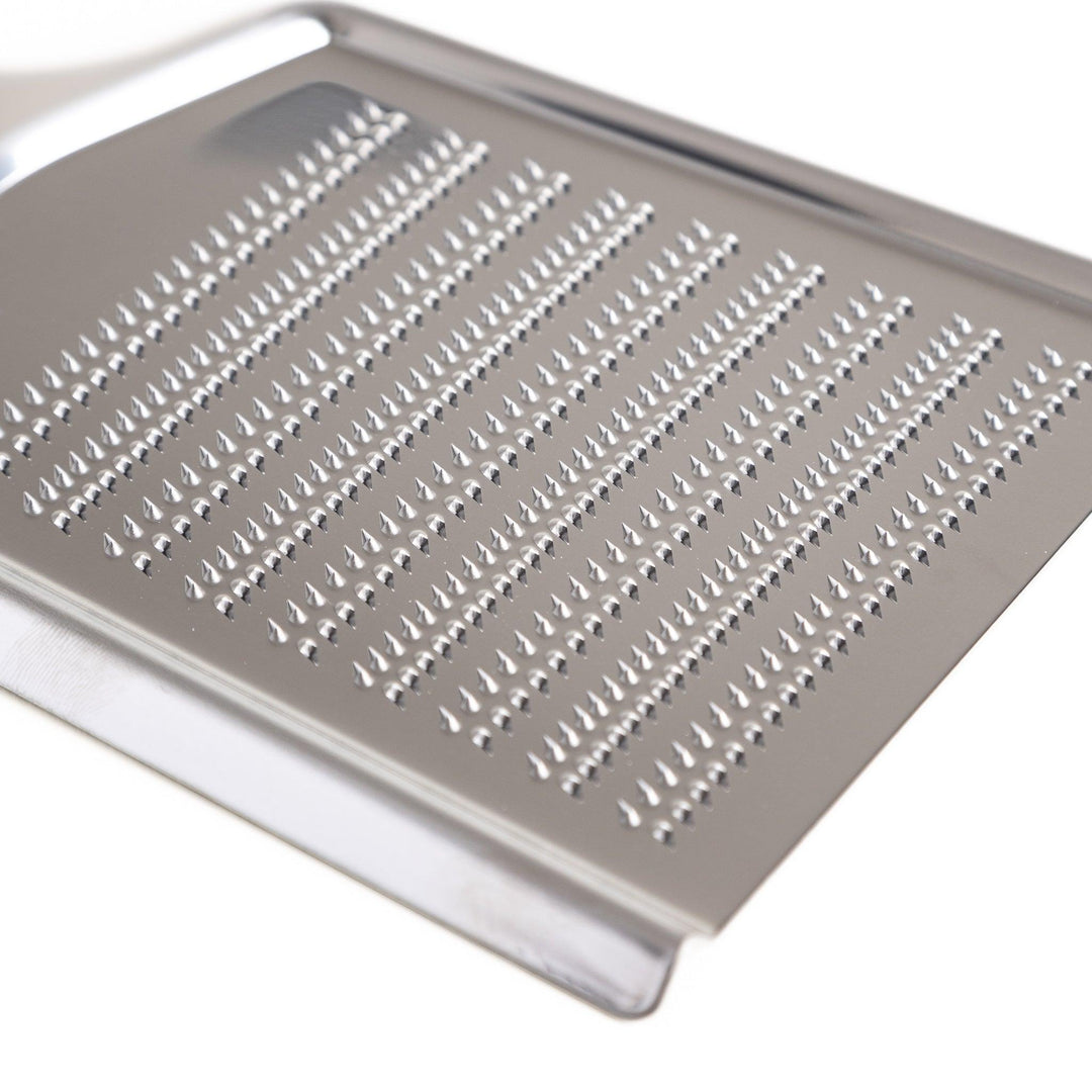 Durable stainless steel grater with sharp blades on both sides, a versatile kitchenware tool for efficiently grating vegetables, cheese, and other ingredients.