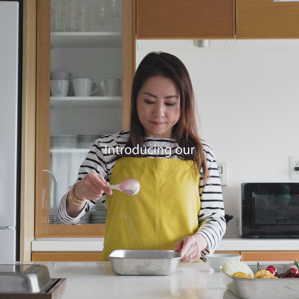 Sprinkling spices onto raw meat with a maraca shaped spice sifter kitchen cooking utensil