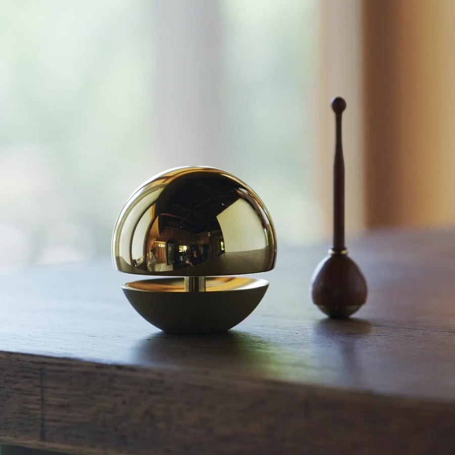 A Japanese brass meditation chime, producing clear and soothing tones when gently struck with a stick.