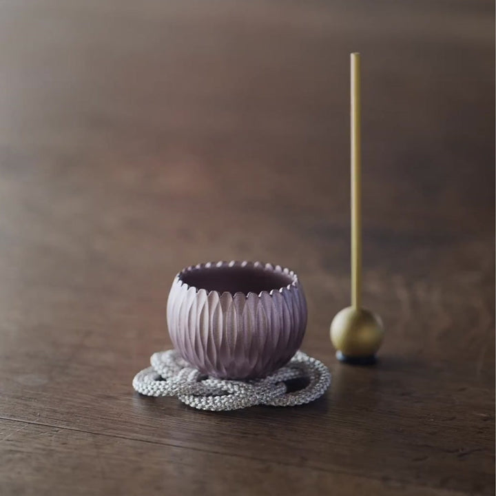 A Japanese brass prayer and meditation bowl decorated with hydrangea motifs, gently played with a mallet.