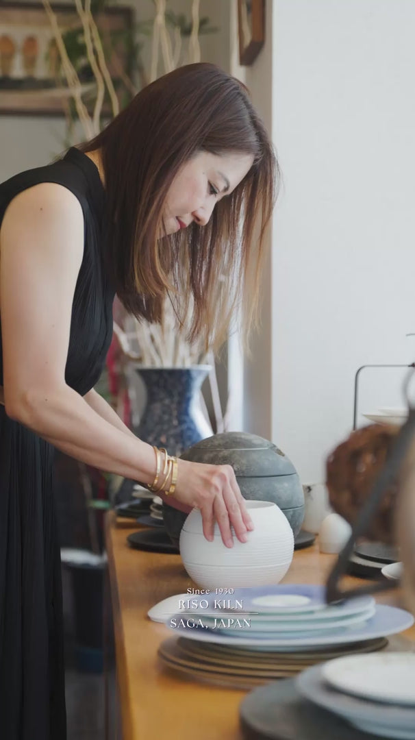 Japanese ceramic artisan shaping, glazing, and firing white porcelain tableware at Riso Kiln workshop in Saga Japan