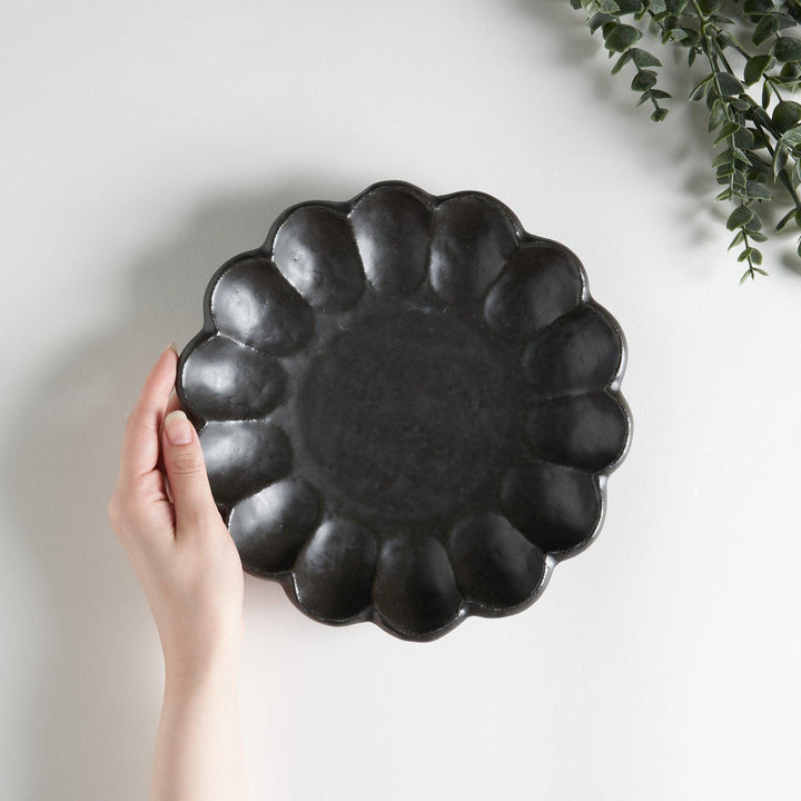 White ceramic salad plate with petal-like, scalloped edges, available in black and white.