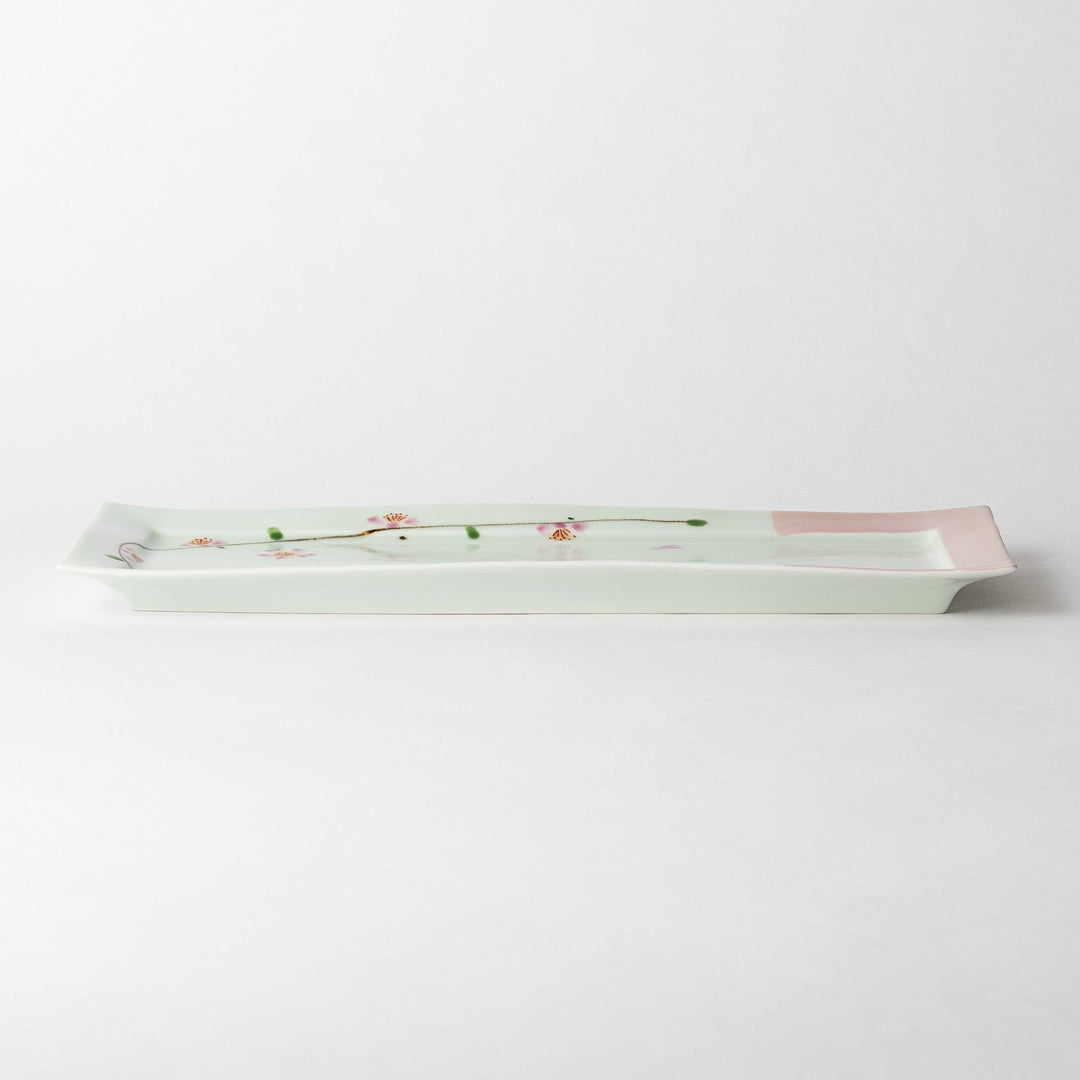 Side view of a rectangular plate featuring cherry blossoms, emphasizing its slim profile and elegant design.