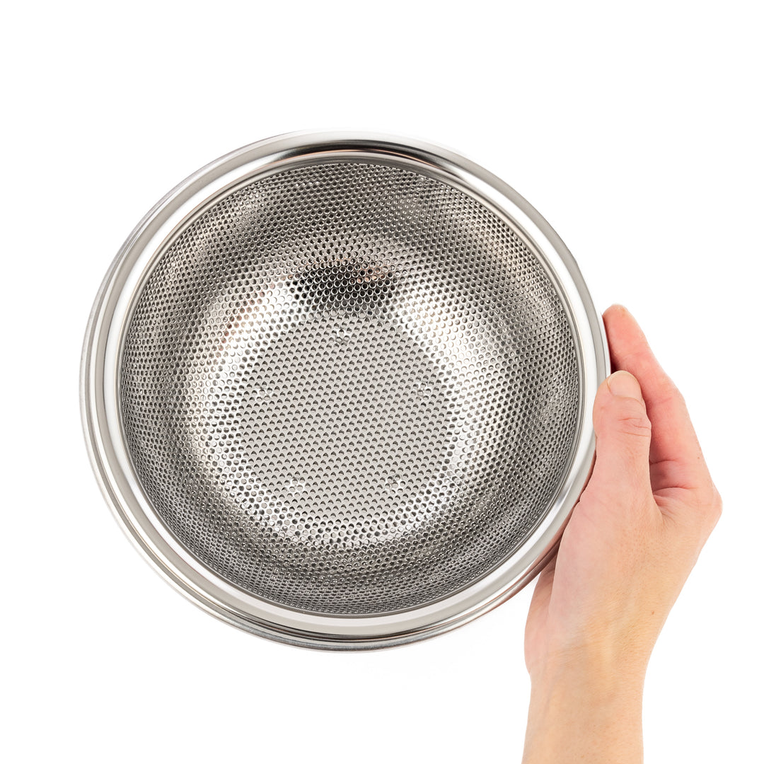 Compact stainless steel mesh strainer bowl with precision-punched holes and sturdy rim, perfect for small-scale rinsing and draining tasks.