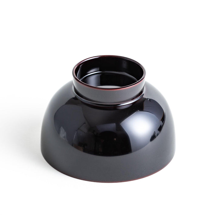 Traditional black lacquer bowl with red interior, featuring a gold pine tree design on the lid.