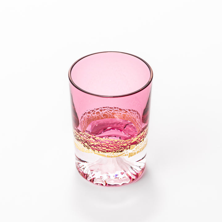 Pink sake glass with shimmering gold-leaf mountain design and a detailed Mount Fuji sculpted at the base, perfect for festive and elegant settings.