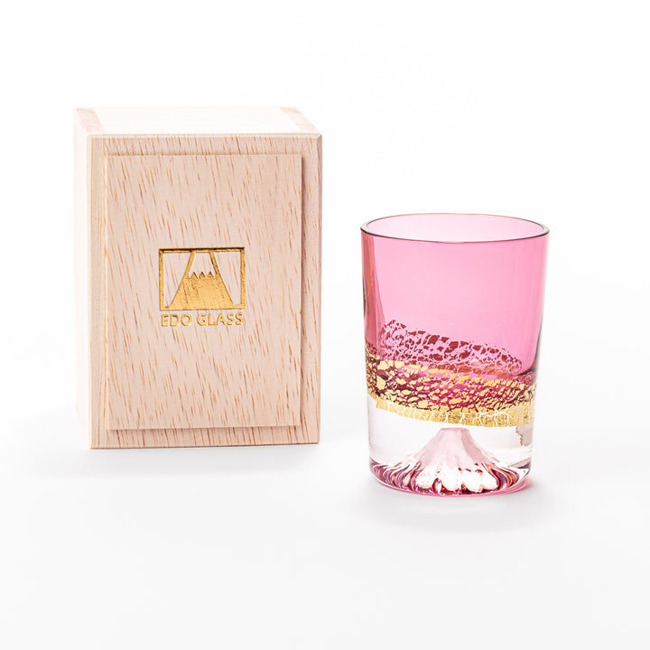 Pink sake glass with shimmering gold-leaf mountain design and a detailed Mount Fuji sculpted at the base, perfect for festive and elegant settings.