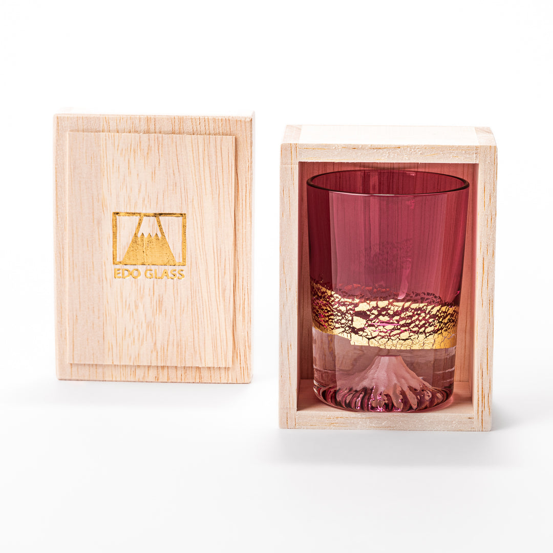 Pink sake glass with shimmering gold-leaf mountain design and a detailed Mount Fuji sculpted at the base, perfect for festive and elegant settings.