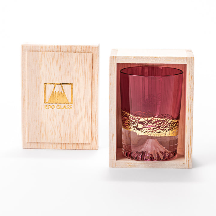 Pink sake glass with shimmering gold-leaf mountain design and a detailed Mount Fuji sculpted at the base, perfect for festive and elegant settings.