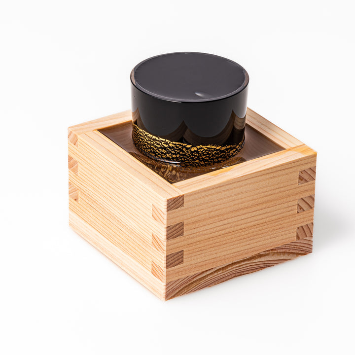 Black and clear sake glass with striking gold-leaf landscape and a Mount Fuji sculpture at the base, offering a bold take on Japanese elegance.