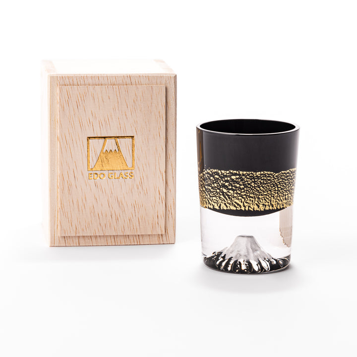 Black and clear sake glass with striking gold-leaf landscape and a Mount Fuji sculpture at the base, offering a bold take on Japanese elegance.