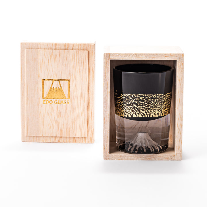 Black and clear sake glass with striking gold-leaf landscape and a Mount Fuji sculpture at the base, offering a bold take on Japanese elegance.