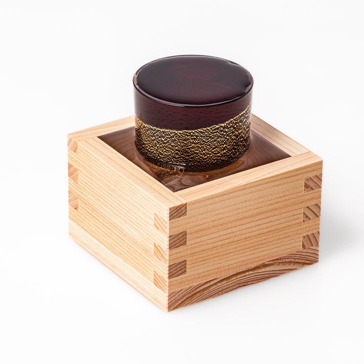 Deep red sake glass adorned with rich gold-leaf mountain scenery and a sculpted Mount Fuji at the base, offering a refined Japanese aesthetic.