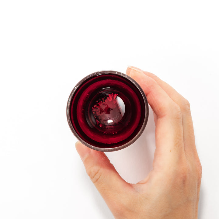 Deep red sake glass adorned with rich gold-leaf mountain scenery and a sculpted Mount Fuji at the base, offering a refined Japanese aesthetic.