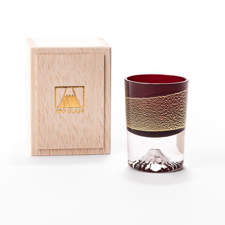 Deep red sake glass adorned with rich gold-leaf mountain scenery and a sculpted Mount Fuji at the base, offering a refined Japanese aesthetic.