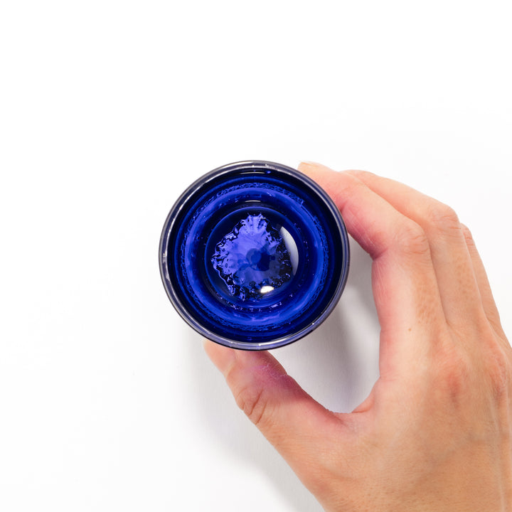 Deep blue sake glass with gold-leaf landscape design and detailed Mount Fuji motif sculpted inside the base, blending tradition and artistry.