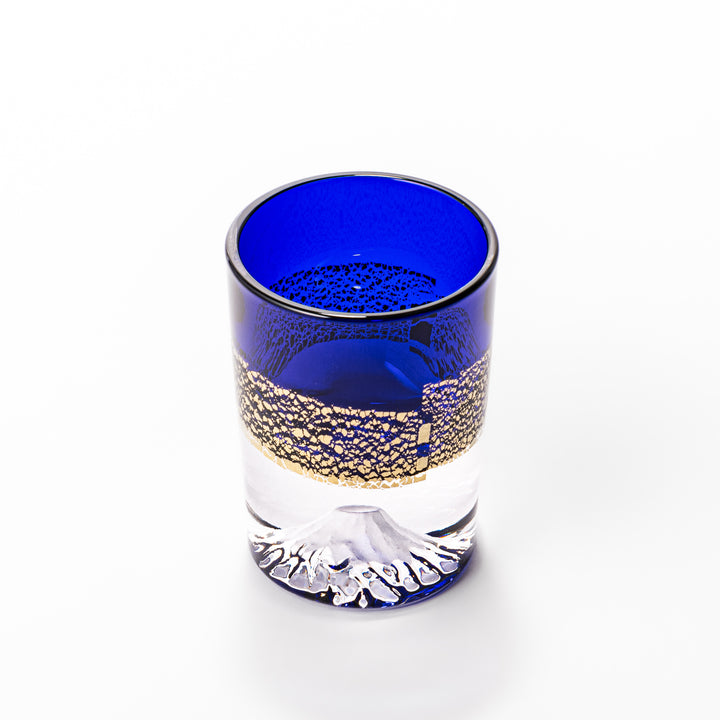Deep blue sake glass with gold-leaf landscape design and detailed Mount Fuji motif sculpted inside the base, blending tradition and artistry.