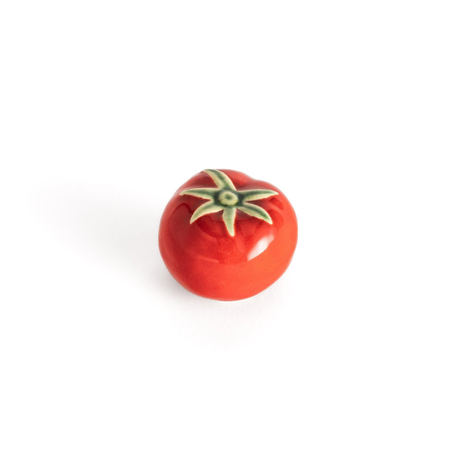Glossy red ceramic tomato chopstick rest with a green stem detail, adding a playful yet elegant touch to your tableware setting.