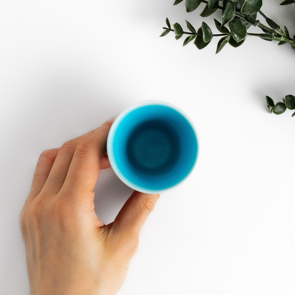 Turkish blue mini cup with a smooth matte finish and contrasting white base, perfect for serving small beverages or adding a pop of color to your tableware.