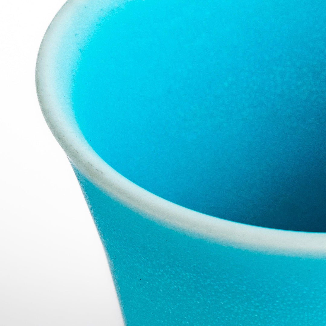 Turkish blue mini cup with a smooth matte finish and contrasting white base, perfect for serving small beverages or adding a pop of color to your tableware.