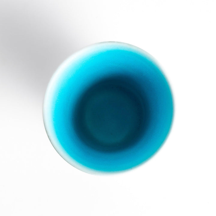 Turkish blue mini cup with a smooth matte finish and contrasting white base, perfect for serving small beverages or adding a pop of color to your tableware.