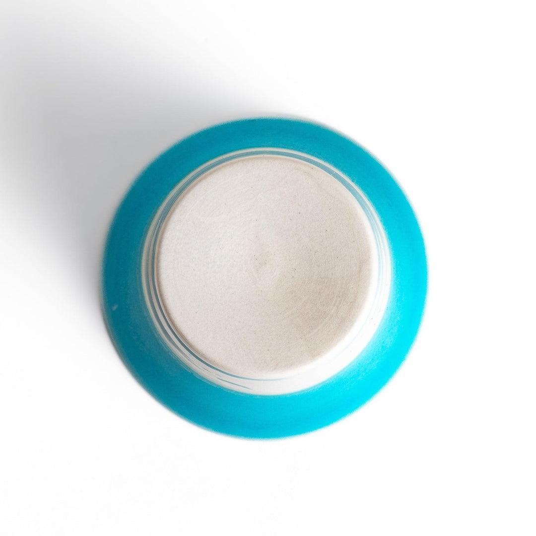 Turkish blue mini cup with a smooth matte finish and contrasting white base, perfect for serving small beverages or adding a pop of color to your tableware.