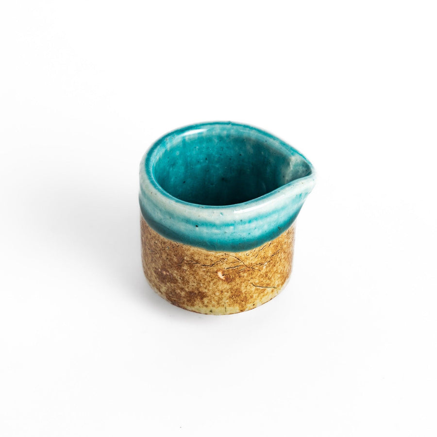 Turkish blue sauce pourer with a smooth turquoise glaze on the top and a textured, earthy base, perfect for serving sauces or dressings.