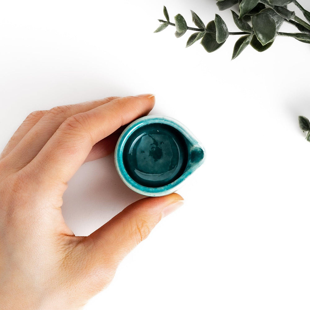 Turkish blue sauce pourer with a smooth turquoise glaze on the top and a textured, earthy base, perfect for serving sauces or dressings.