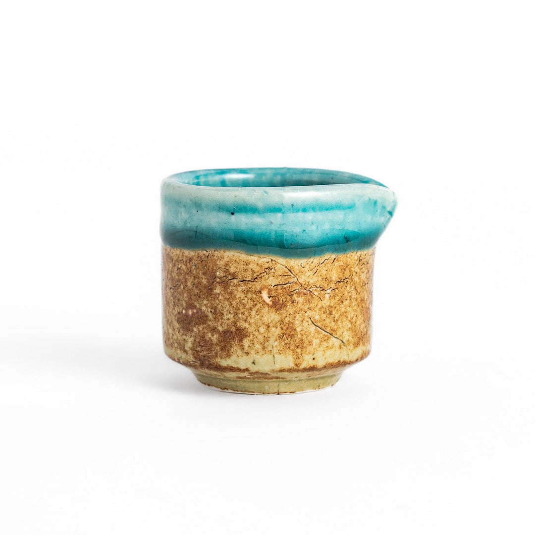 Turkish blue sauce pourer with a smooth turquoise glaze on the top and a textured, earthy base, perfect for serving sauces or dressings.