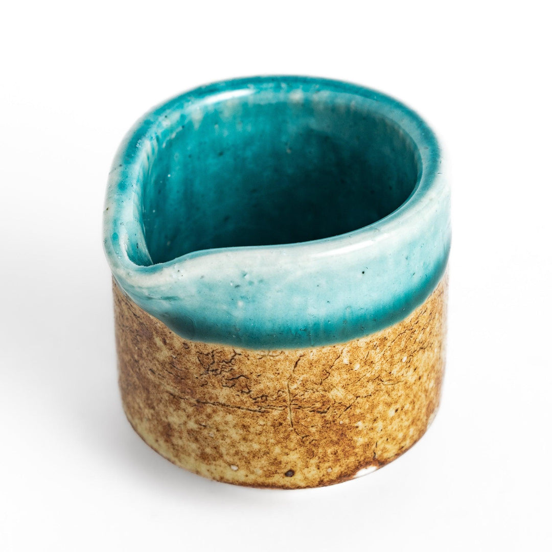 Turkish blue sauce pourer with a smooth turquoise glaze on the top and a textured, earthy base, perfect for serving sauces or dressings.